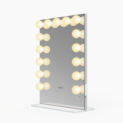 Side view of the small Riki Loves Riki Hollywood mirror with warm light.